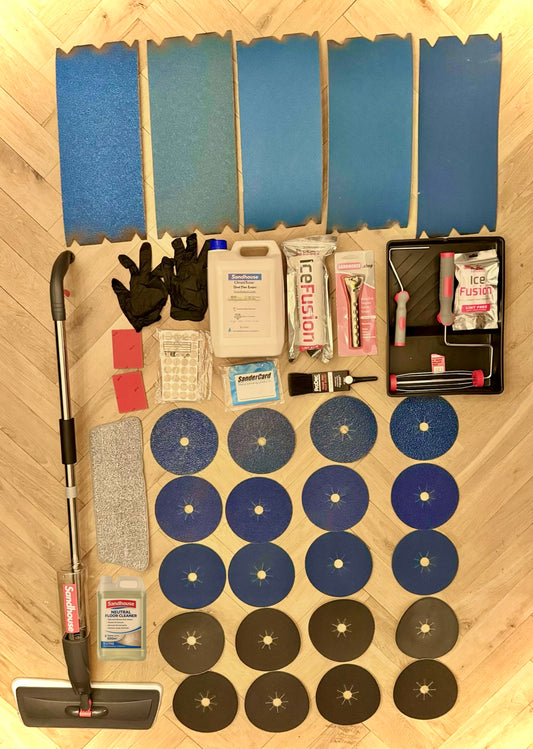 Collection of tools and materials on a wooden floor for floor sanding